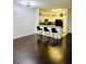 Open-concept room showcasing hardwood floors, bar stools, and a bright white kitchen in the background at 870 Mayson Turner Rd # 1207, Atlanta, GA 30314