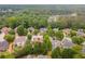 An aerial view of this home, surrounded by mature trees in a quiet residential area near a lake at 300 Brackin Trce, Grayson, GA 30017