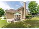 Back patio features a dining table with chairs, landscaping, and a view of the house's exterior at 300 Brackin Trce, Grayson, GA 30017