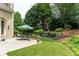 A lush backyard with a patio seating area, swing, and nicely landscaped garden at 300 Brackin Trce, Grayson, GA 30017