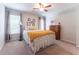 Bedroom featuring a metal-framed bed, a floor lamp, and a wooden dresser, all illuminated by natural light at 300 Brackin Trce, Grayson, GA 30017