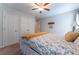 Bedroom featuring a patterned bed, complemented by white walls, ceiling fan, closet, and modern furnishings at 300 Brackin Trce, Grayson, GA 30017
