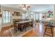 Open concept living and dining room featuring wood floors, fireplace, and vintage decor at 300 Brackin Trce, Grayson, GA 30017