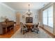 Cozy dining room featuring a chandelier, hardwood floors, and natural light from a large window at 300 Brackin Trce, Grayson, GA 30017