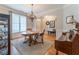 Charming dining room showcases a round table, decorative chandelier, and elegant window treatments at 300 Brackin Trce, Grayson, GA 30017