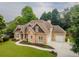 Attractive stone-accented home with manicured lawn, mature trees, and charming curb appeal at 300 Brackin Trce, Grayson, GA 30017