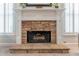Close-up view of the living room's stone fireplace with decorative mantel and shuttered windows at 300 Brackin Trce, Grayson, GA 30017