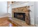 Living room fireplace with stone hearth and gas logs at 300 Brackin Trce, Grayson, GA 30017