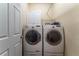 Laundry room with white front loading washer and dryer, white cabinets and door at 300 Brackin Trce, Grayson, GA 30017