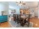 Open concept living and dining room featuring wood floors, fireplace, and vintage decor at 300 Brackin Trce, Grayson, GA 30017