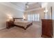 Spacious bedroom featuring a tray ceiling, fan, large window and ensuite bathroom at 300 Brackin Trce, Grayson, GA 30017
