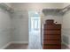 Spacious walk-in closet featuring built-in shelving, wooden dresser, and a glimpse of the bedroom at 300 Brackin Trce, Grayson, GA 30017
