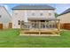 A spacious backyard with a wooden deck and seating area, perfect for outdoor relaxation and entertaining at 3303 Hawthorn Farm Blvd, Loganville, GA 30052