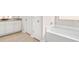 Bathroom featuring a soaking tub, tiled floors, and single sink vanity at 3303 Hawthorn Farm Blvd, Loganville, GA 30052