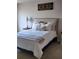Cozy bedroom featuring carpeted floors, a queen bed, and a nightstand at 3303 Hawthorn Farm Blvd, Loganville, GA 30052