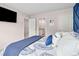 Bedroom with a blue accent wall, a queen bed, and access to a full bathroom at 3303 Hawthorn Farm Blvd, Loganville, GA 30052
