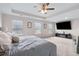 Spacious bedroom featuring a ceiling fan, a large TV, and carpeted floors at 3303 Hawthorn Farm Blvd, Loganville, GA 30052