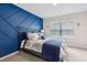 Bedroom with an accent wall, a queen bed, and a window at 3303 Hawthorn Farm Blvd, Loganville, GA 30052