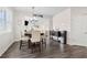 Dining area with modern pendant lighting fixture and an open layout to the living area at 3303 Hawthorn Farm Blvd, Loganville, GA 30052