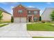 Charming two-story brick home with a well-manicured lawn and two-car garage in a desirable neighborhood at 3303 Hawthorn Farm Blvd, Loganville, GA 30052