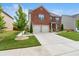 Beautifully landscaped two-story brick home with a two-car garage and lush green lawn at 3303 Hawthorn Farm Blvd, Loganville, GA 30052