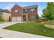 Beautifully landscaped two-story brick home with a two-car garage and lush green lawn at 3303 Hawthorn Farm Blvd, Loganville, GA 30052
