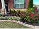Beautiful, lush landscaping frames the home's entrance, adding curb appeal at 3303 Hawthorn Farm Blvd, Loganville, GA 30052