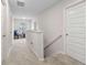Upstairs hallway with neutral carpet and a blue accent chair at 3303 Hawthorn Farm Blvd, Loganville, GA 30052