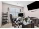 This home office is equipped with a TV monitor and shelving to maximize the available space at 3303 Hawthorn Farm Blvd, Loganville, GA 30052