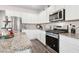 Bright kitchen features stainless steel appliances, granite countertops, and ample white cabinetry at 3303 Hawthorn Farm Blvd, Loganville, GA 30052