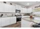 A well-appointed kitchen boasts granite countertops, stainless steel appliances, and white cabinets at 3303 Hawthorn Farm Blvd, Loganville, GA 30052