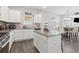 Open kitchen with island and stainless steel appliances connects to the dining area at 3303 Hawthorn Farm Blvd, Loganville, GA 30052