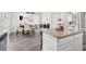 Open concept kitchen with stainless steel appliances, island and dining area with great natural light at 3303 Hawthorn Farm Blvd, Loganville, GA 30052