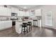 Bright kitchen featuring white cabinets, a central island, stainless steel appliances and outdoor access at 3303 Hawthorn Farm Blvd, Loganville, GA 30052