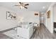 Bright living room with fireplace, ceiling fan and hardwood floors at 3303 Hawthorn Farm Blvd, Loganville, GA 30052