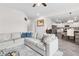 Open-concept living room features a neutral palette, gray plank floors, and a seamless flow to the modern kitchen at 3303 Hawthorn Farm Blvd, Loganville, GA 30052