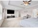 Spacious main bedroom with plush carpet, ceiling fan, and a large TV at 3303 Hawthorn Farm Blvd, Loganville, GA 30052