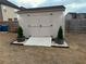 A well-maintained storage shed in backyard with a ramp and decorative landscaping at 3303 Hawthorn Farm Blvd, Loganville, GA 30052