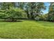 Large, grassy backyard with mature trees, offering a private outdoor space at 4177 Hapsburg Ct, Decatur, GA 30034