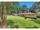 Beautifully landscaped front yard showcasing a charming brick home with manicured shrubs and mature trees at 4177 Hapsburg Ct, Decatur, GA 30034