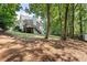 Picturesque backyard featuring a spacious deck, lush greenery, and mature trees at 6985 Shane Ln, Cumming, GA 30028