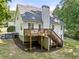 Back of home showing deck and walkout basement in a lush landscaped yard at 6985 Shane Ln, Cumming, GA 30028