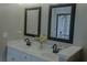 Bathroom with dual sinks, framed mirrors, and sleek fixtures that create a modern and stylish space at 6985 Shane Ln, Cumming, GA 30028