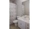 Cozy bathroom features a vanity with drawers, toilet, and a shower with a patterned curtain at 6985 Shane Ln, Cumming, GA 30028