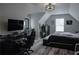 Bedroom featuring a bed, a desk with a PC, and an elegant ceiling light fixture at 6985 Shane Ln, Cumming, GA 30028