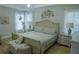 Bright bedroom offering a comfortable bed, bedside tables, and soft natural light through sheer curtains at 6985 Shane Ln, Cumming, GA 30028