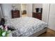 Bedroom with hardwood flooring, large dresser and bed with green and white bed spread at 6985 Shane Ln, Cumming, GA 30028