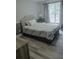 Inviting bedroom with a comfortable bed, side table, lamp, and large window with curtains at 6985 Shane Ln, Cumming, GA 30028