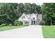 Charming two-story home with manicured lawn, complemented by lush, mature trees at 6985 Shane Ln, Cumming, GA 30028