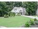 Beautiful two-story home with lush lawn, mature trees, and meticulously maintained landscaping at 6985 Shane Ln, Cumming, GA 30028